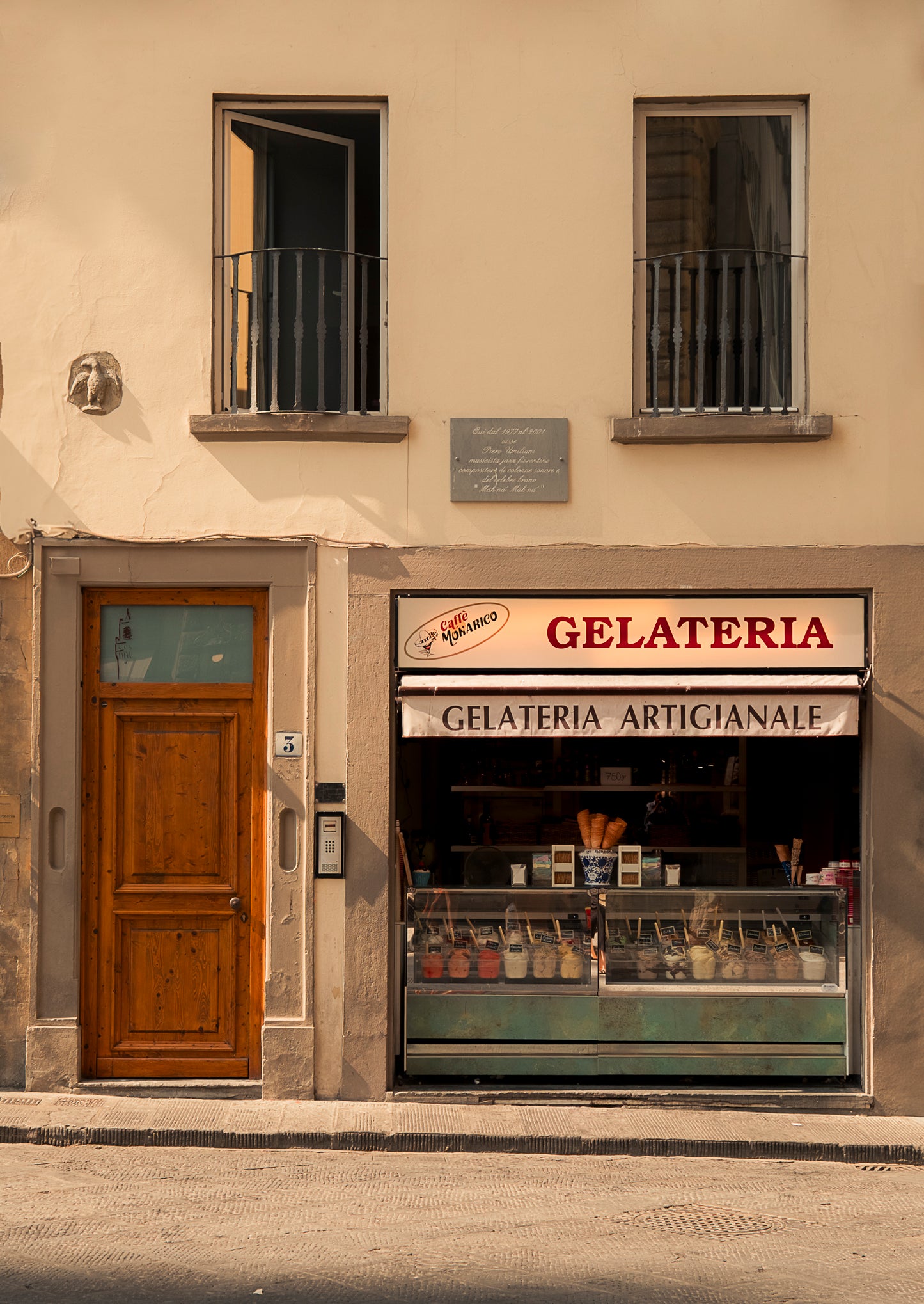 Italian Gelateria with a wooden door and balcony above