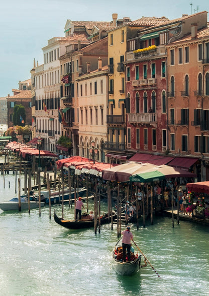 Venetian canal with gondolas and colorful buildings in Venice, Italy